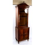 A late Victorian narrow mahogany bookcase, with fielded panelled cupboard below, width 66cm,