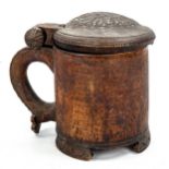 A Norwegian birch peg tankard, 18th or 19th century, the domed lid carved in low relief depicting