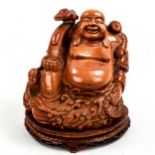 A Chinese carved goldstone Buddha on hardwood stand, height 28cm