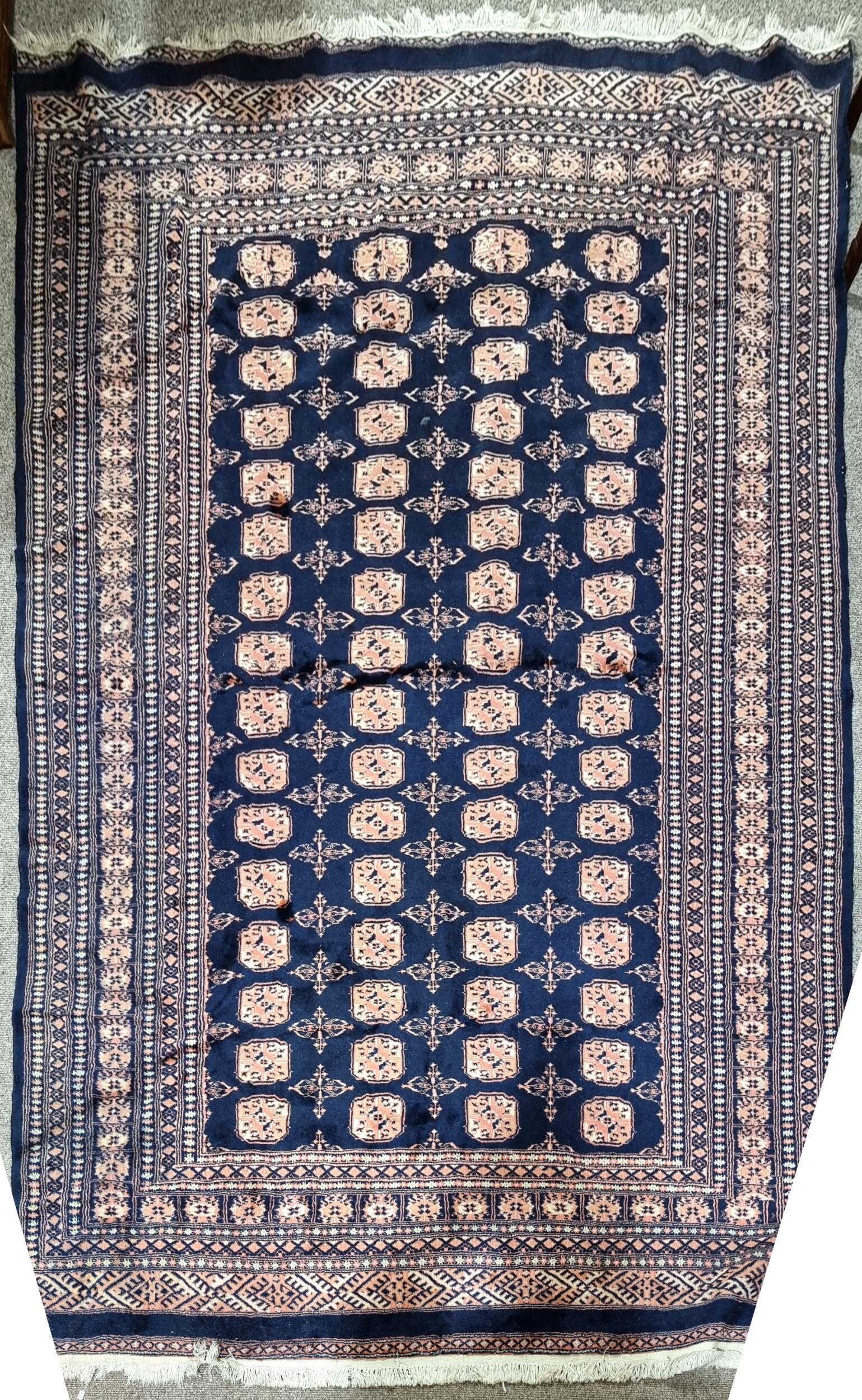 A blue ground Tekke wool rug, 284cm x 195cm No holes or tears, some discolouration and staining.