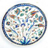 Turkish Iznik pottery plate with hand painted decoration, diameter 29cm Several very small glaze
