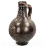 17th century salt glaze pottery bellarmine flagon, with relief moulded coat of arms, height 21cm
