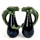 A pair of treacle glaze pottery jugs, with entwinned gargoyle figures, no factory marks, height 24cm