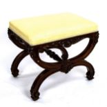 A 19th century walnut X-framed dressing stool, with relief carved and scrolled decoration, 54cm x