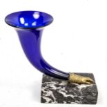 A Victorian Bristol blue glass cornucopia vase, on grey marbled base with gloved hand mount,
