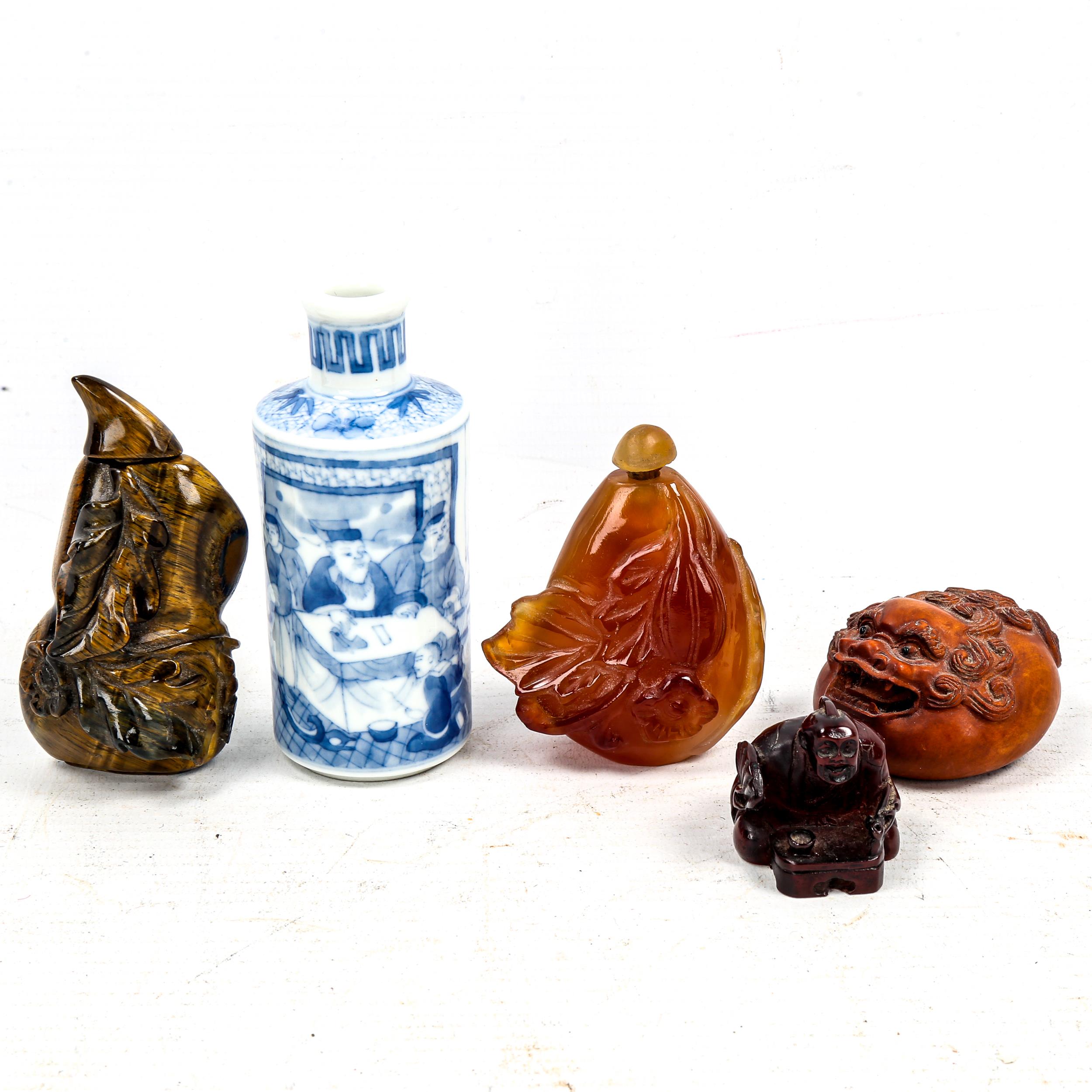 A group of Oriental cabinet items, including a relief carved tigers eye snuff bottle and stopper,
