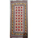 A vegetable dyed Kelim rug, 290cm x 145cm Outer band of decoration has a few holes and tears, centre