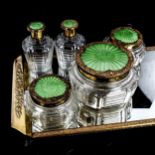 A glass and green enamel dressing table set, on brass-mounted mirrored stand, stand length 35cm