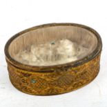 A 19th century oval gilt-metal trinket box with bevel-glass panelled hinged lid, length 13.5cm