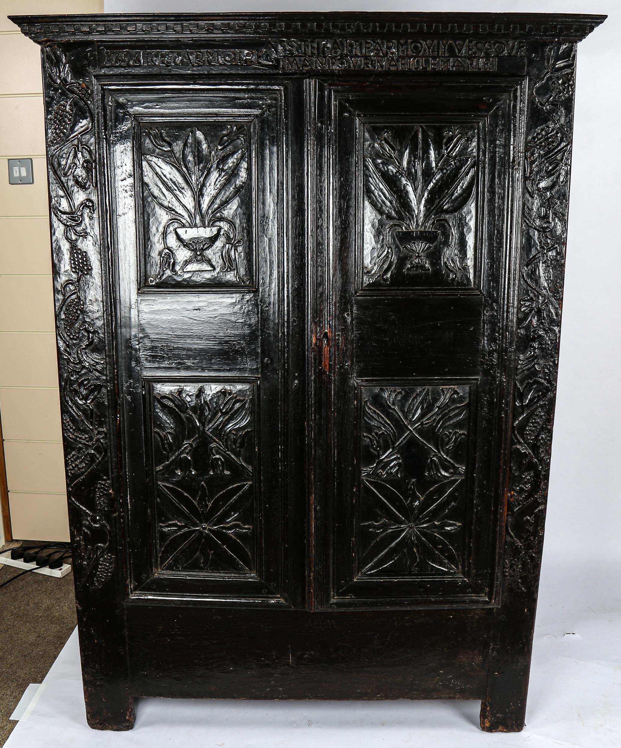 A 17th century French panelled oak 2-door armoire, original marriage inscription to the frieze dated