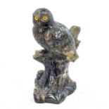 A carved labradorite stone owl on a branch, height 10cm Chipped tail and branch