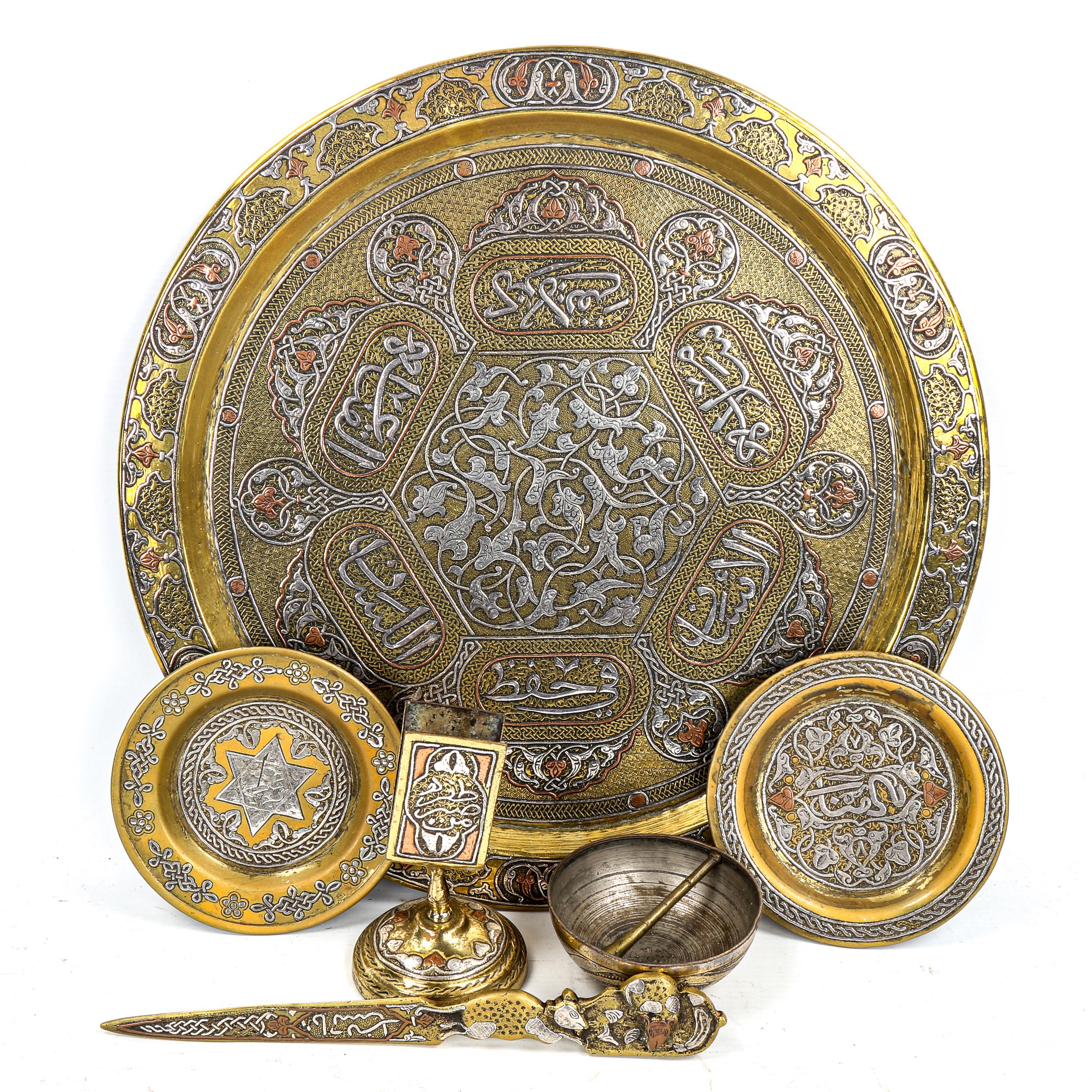 A group of Persian brass items, comprising a circular tray, diameter 38cm, a relief