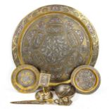 A group of Persian brass items, comprising a circular tray, diameter 38cm, a relief
