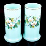 A pair of blue opaline glass vases with enamelled flower decoration