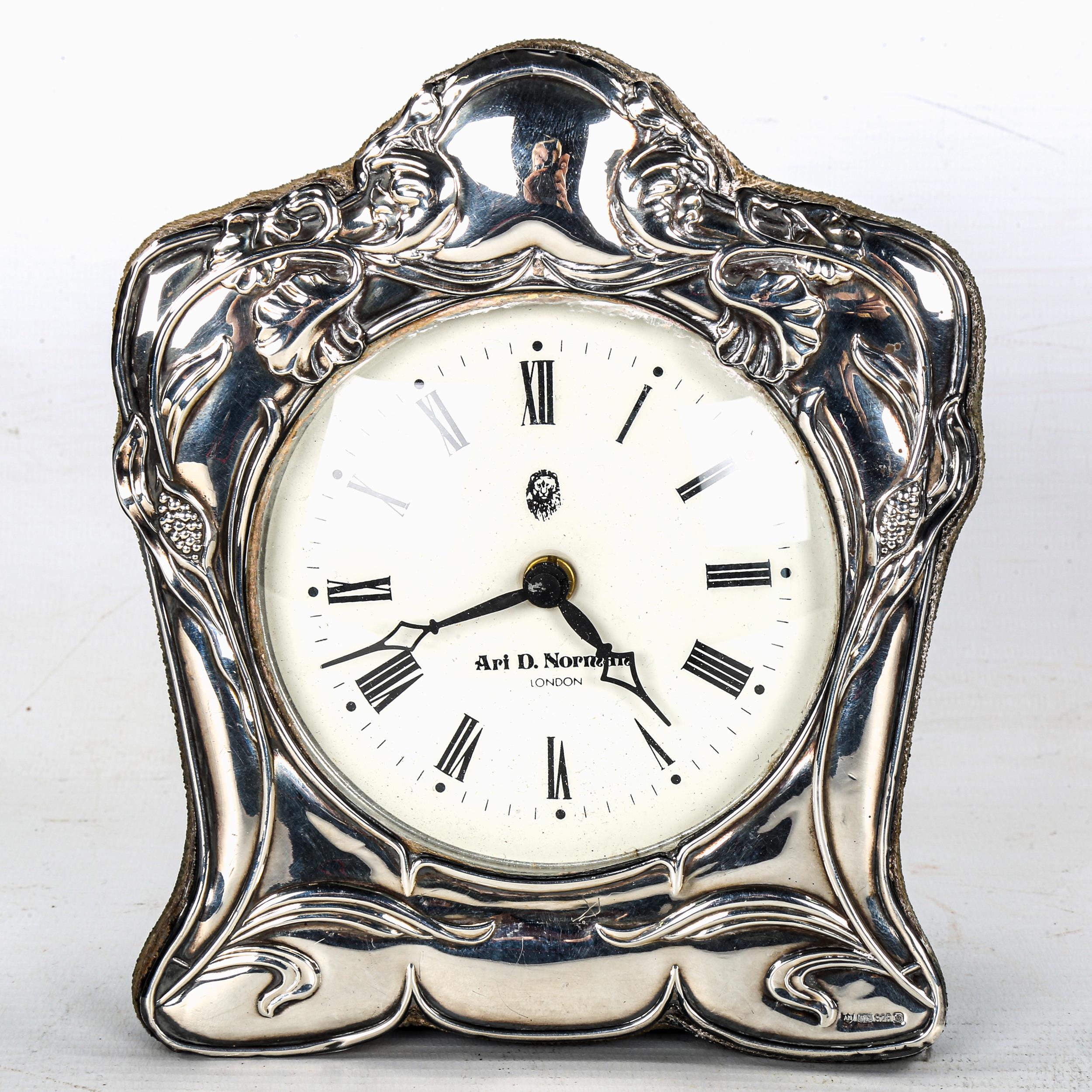 An Art Nouveau style silver framed clock