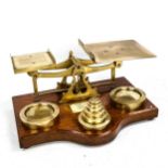 A set of large Victorian brass postal balance scales and weights, on oak base, width 38cm