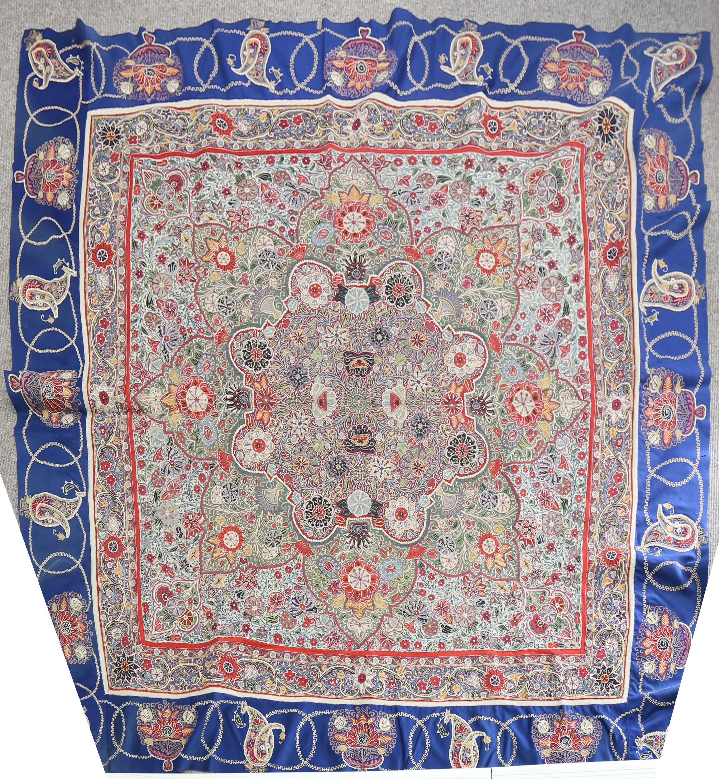 A fine quality Oriental hand embroidered crewelwork table cover, the central panel intricately