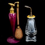 A cut-glass silver and yellow enamel-topped atomiser perfume bottle, height 15cm, and a pink glass