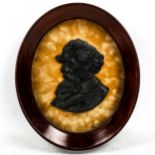 A relief cast bronze portrait plaque of Charles Dickens, in original oval mahogany frame, frame