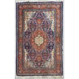 An Antique Turkish blue ground wool rug, floral design, 150cm x 100cm Edges have a few small
