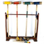 A lovely early 20th century child's croquet set complete with stand