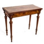 A 19th century rectangular walnut fold over card table, on turned and fluted legs, 85cm x 42cm,