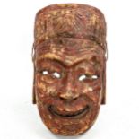 A Chinese Nuo opera mask of Tudi Gong, relief carved and painted wood, on wooden stand, height