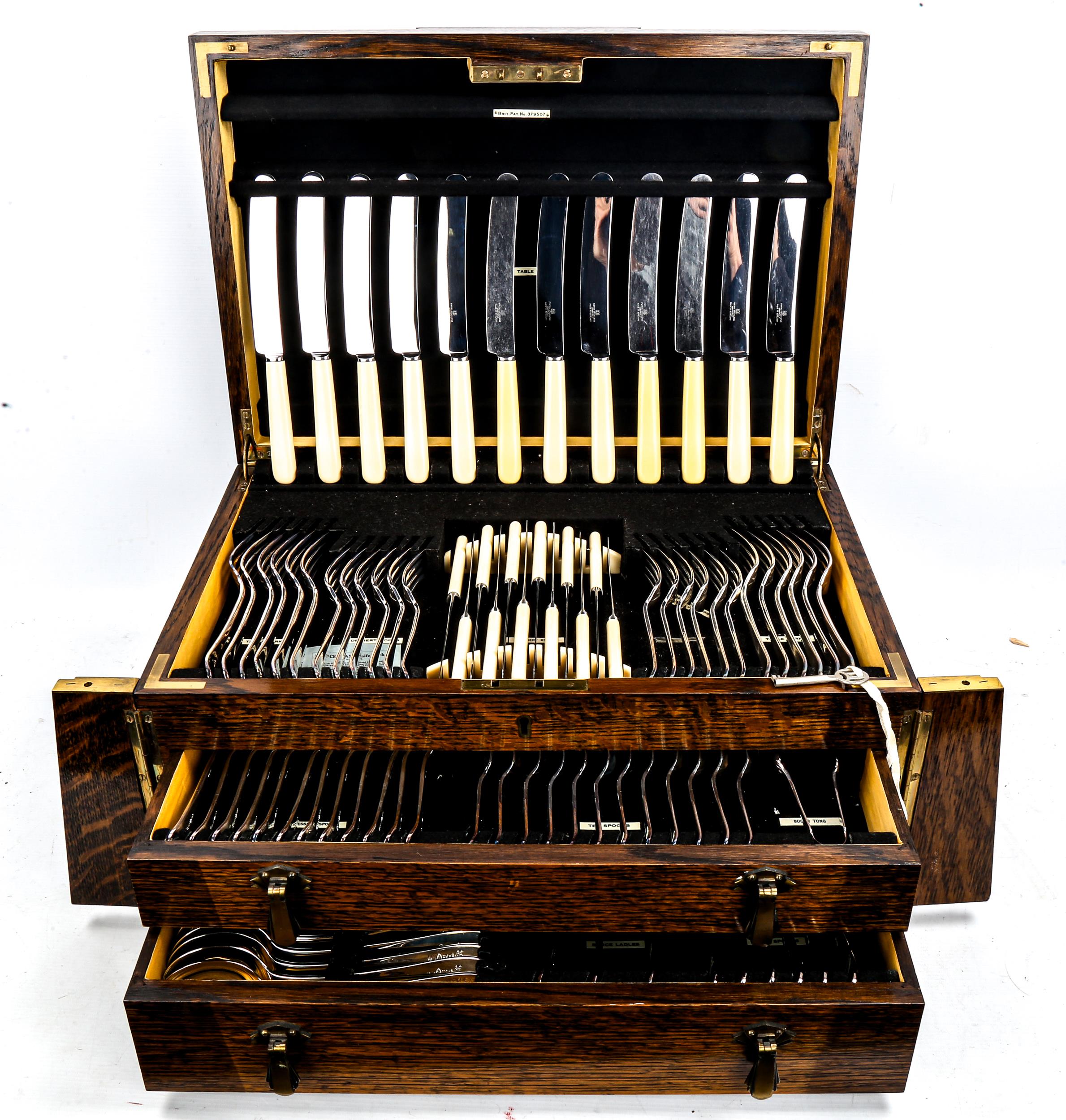 A canteen of Unity Old English pattern cutlery and servers for 12 people, in an oak cabinet with 2