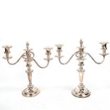 A pair of silver plated three-light candelabra, with gardooned rims, flame finial centre sconces and