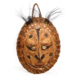 A South Seas turtle shell and wicker wall-hanging Tribal mask ornament, with applied shells and