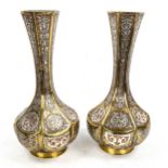 A pair of Persian brass narrow-necked vases, with intricate inlaid silver and