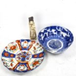 A Chinese blue and white porcelain bowl, diameter 18cm, a Japanese Imari porcelain plate, and an