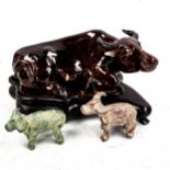 A Chinese brown treacle glaze pottery buffalo on hardwood stand, length 21cm, and 2 miniature