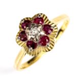 A late 20th century 18ct gold ruby and diamond cluster flowerhead ring, set with round cut stones,