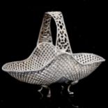 An Eastern silver bon bon basket, pierced lattice and foliate decoration, marked 900, length 19.5cm,