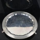 An Art Deco George V circular silver salver, engine turned decoration standing on three feet, by