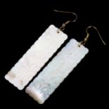 A pair of Chinese mother-of-pearl gaming counter earrings, rectangular form with engraved floral