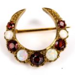 A late 20th century 9ct gold opal and garnet crescent brooch, set with round cabochon opals and
