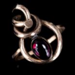 An Arts and Crafts cabochon garnet rope ring, unmarked gold settings with oval cabochon garnet in