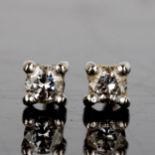 A pair of 0.12ct solitaire diamond stud earrings, each set with 0.06ct modern round brilliant-cut