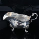 ASPREY - an Elizabeth II cast silver sauce boat, gadrooned rim with scrolled acanthus handle and