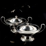 A pair of George III cast silver two-handled sauce tureens and covers, of boat shape with beaded