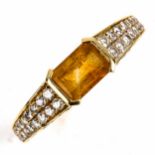 A modern 18ct gold citrine and diamond dress ring, set with emerald-cut citrine and modern round