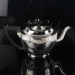 A George V silver teapot, oval form with engraved Adam's style swag decoration and ebonised