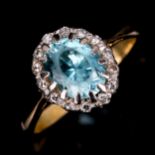 An 18ct gold blue zircon and diamond oval cluster ring, set with oval mixed-cut zircon and single-