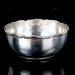 A Middle Eastern silver sugar bowl, with cast floral rim, marks on base, diameter 11cm, 4.2oz No