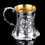 A Victorian silver Christening tankard, flared cylindrical form with relief embossed floral