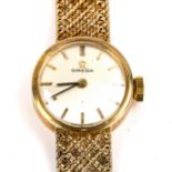 OMEGA - a lady's Vintage 9ct gold mechanical bracelet watch, silvered dial with gilt baton hour