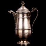 An Antique Continental silver hot chocolate pot, urn form with scrolled acanthus leaf handle, marked