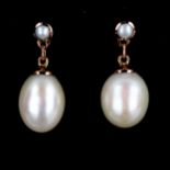 A modern pair of unmarked rose gold pearl drop earrings, settings test as 9ct gold, earring height